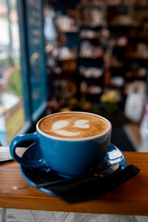 Coffee cup. Blue coffee cup with latte art in a heart shape.